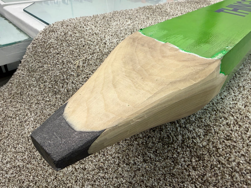 The tip of an extremely large carpenter pencil, sitting on a carpet